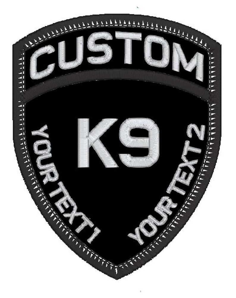 May include: Black and white embroidered patch with the text "CUSTOM" at the top, "K9" in the centre, and "YOUR TEXT 1" and "YOUR TEXT 2" on the sides.