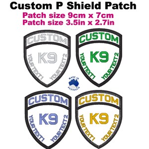 May include: Four custom embroidered patches in the shape of a shield. The patches are white with black outlines and feature the text "CUSTOM" at the top, "K9" in the centre, and "YOUR TEXT1 YOUR TEXT2" wrapped around the bottom. The patches are available in four different colours: silver, green, blue, and gold.