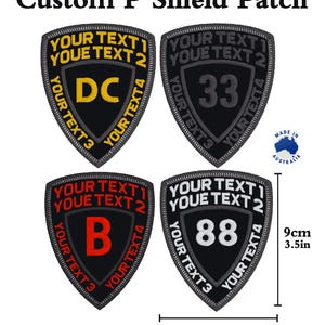 May include: Four black and grey custom embroidered patches in the shape of a shield. Each patch has a different design, including the letters "DC", the number "33", the letter "B", and the number "88". The patches are 7 cm wide and 9 cm tall.