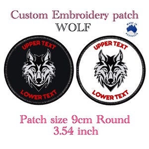 May include: Two round embroidered patches featuring a wolf design. The patches are 9cm in diameter and have black and white backgrounds with a grey wolf design. The text "UPPER TEXT" and "LOWER TEXT" is in red on both patches.