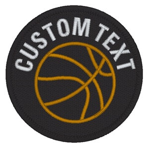 May include: Black and white embroidered patch with a gold basketball and the text "CUSTOM TEXT" around the basketball.