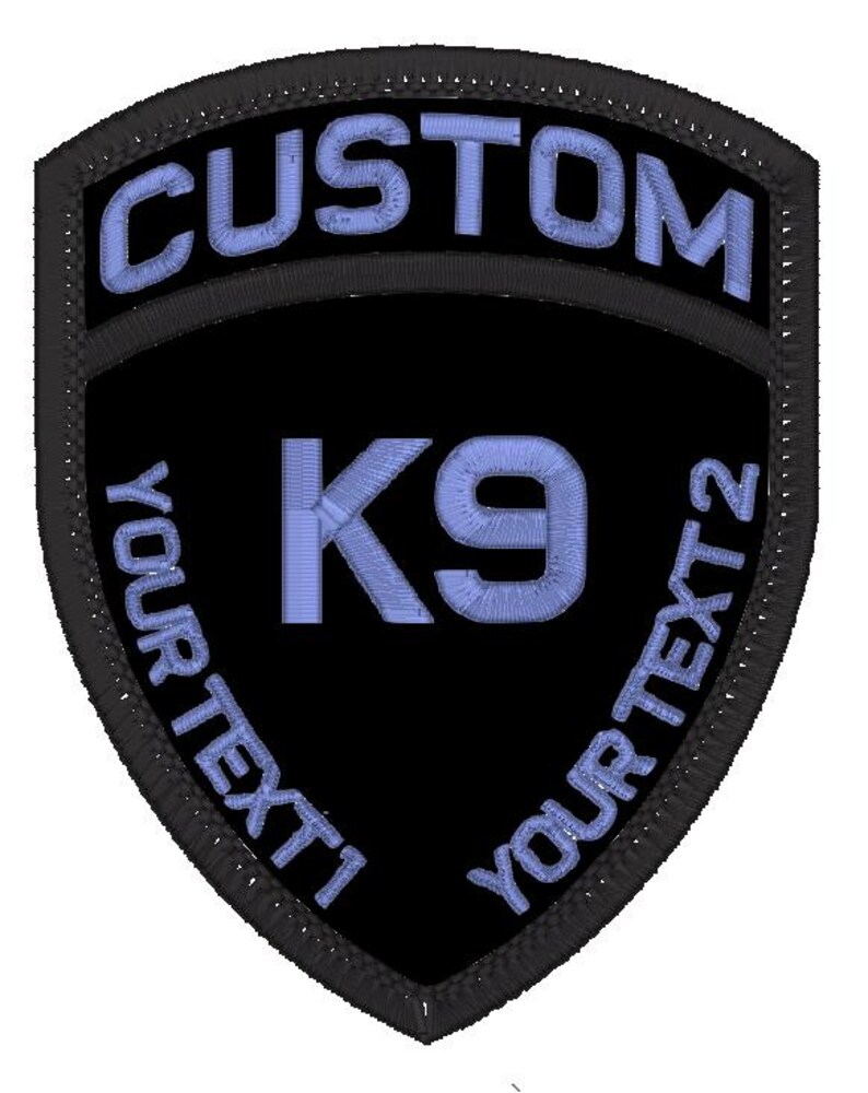 May include: Black and blue embroidered patch in the shape of a shield. The patch says "CUSTOM" at the top and "YOUR TEXT 1" and "YOUR TEXT 2" on the sides. In the centre is the text "K9" in blue.