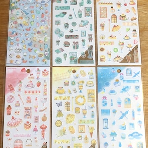 May include: Six sheets of colorful stickers with various designs. The stickers feature illustrations of desserts, seashells, and other whimsical designs. The stickers are perfect for adding a touch of personality to journals, planners, and other craft projects.