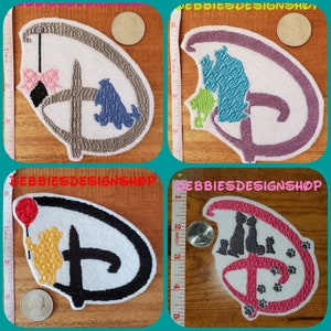 May include: Four embroidered iron-on patches featuring the Disney logo with different characters. The first patch is gray and features a black cat with a pink bow and a blue dog. The second patch is purple and features a green, blue, and purple silhouette of a family of cats. The third patch is white and features a yellow bear holding a red balloon. The fourth patch is white and features a pink silhouette of a family of cats with paw prints.