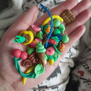 Tiny items objects made of modelling clay baked solid. Non-toxic. Baked in an oven.