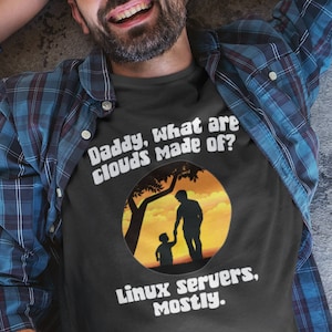 May include: Two people wearing t-shirts with humorous text. The adult's shirt says "Daddy, what are clouds made of? Linux servers, mostly." The child's shirt says "punintentional.us".