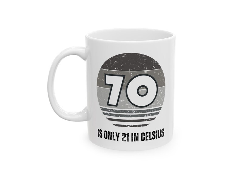 White ceramic mug featuring a vintage-style circular graphic with the number “70” and the text “Is only 21 in Celsius” in black lettering.