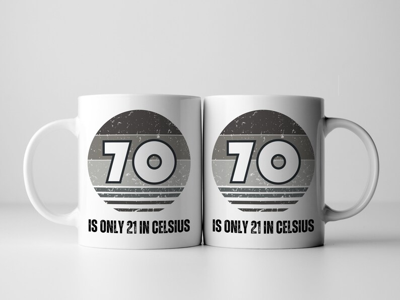A white 11-ounce ceramic mug with a comfortable C-handle and rounded edges. The black and white design displays the words 70 Is Only 21 in Celsius.