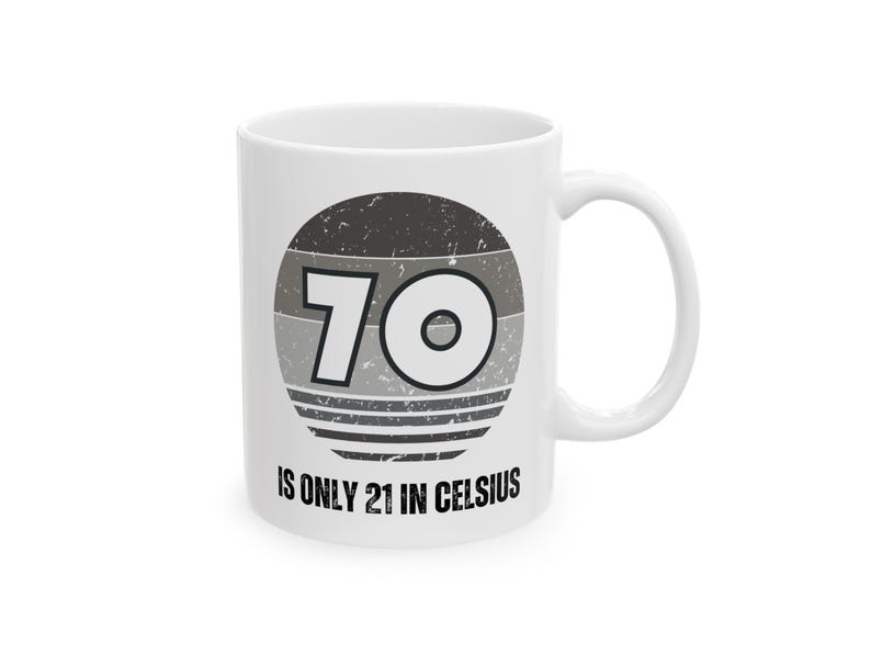 White ceramic mug featuring a vintage-style circular graphic with the number “70” and the text “Is only 21 in Celsius” in black lettering.