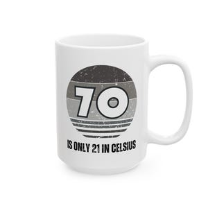 White ceramic mug featuring a vintage-style circular graphic with the number “70” and the text “Is only 21 in Celsius” in black lettering.
