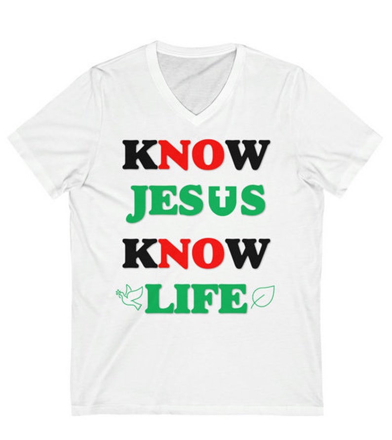 May include: White V-neck t-shirt with the text "KNOW JESUS KNOW LIFE" in black, red, and green letters. A dove and a leaf are on either side of the word "LIFE".