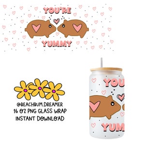 May include: A 16 ounce glass tumbler with a white background and a design of two brown cartoon hamsters kissing with pink hearts and the text "YOU'RE YUMMY".