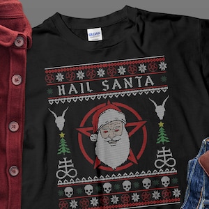 May include: Black t-shirt with a festive "Hail Santa" design. The graphic features Santa Claus with a pentagram, goat heads, Christmas trees, skulls, and the Leviathan Cross. The design is in red, white, and green.