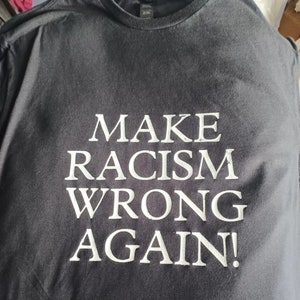 T shirts "Make Racism Wrong Again" and "Invincible Indigenous"