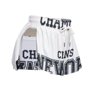 a pair of white shorts with black and white letters
