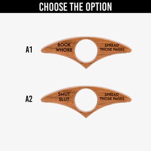 May include: Two wooden book page holders with a finger hole. One is labeled "BOOK WHORE" and the other "SMUT SLUT". Both are labeled "SPREAD THOSE PAGES". The text "CHOOSE THE OPTION" is at the top.