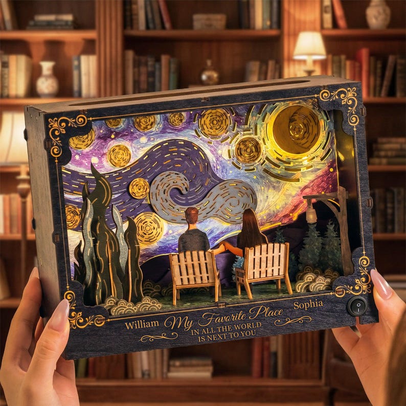 May include: A wooden, illuminated art piece depicting a couple seated on a bench under a starry night sky, reminiscent of Van Gogh's style. The piece includes the text "My Favorite Place" and names "William" and "Sophia".