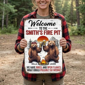 May include: A rustic metal sign with the words "Welcome to the Smith's Fire Pit" and a graphic of two bears toasting with beer. The sign also includes the text "We have booze and open flames, what could possibly go wrong?"