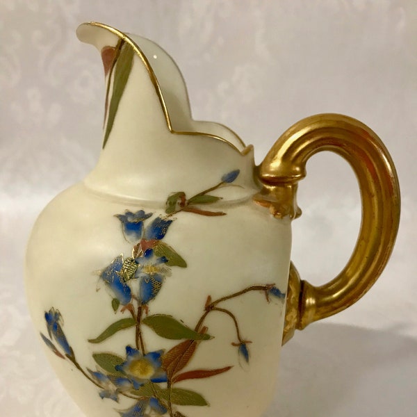 A beautiful rare British Royal Worcester milk jug from 1885 with gold coloured rim and handle and floral pattern. So Vintage! Very Classic!