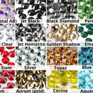 May include: Assortment of rhinestones in various colors, including AB (Crystal AB), Jet Black, Black Diamond, Peridot, Crystal Clear, Jet Hematite, Golden Shadow, Emerald, Light Siam, Silver, Topaz, Blue Zircon, Siam, Aurum (gold), Citrine, and Aquamarine.