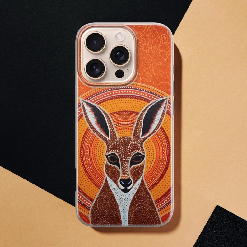 Flat lay close-up of orange kangaroo Aboriginal dot art phone case, slim design with raised bumper around camera cutout