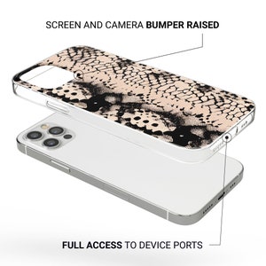 May include: A clear phone case with a raised black and beige snake skin pattern. The case has a raised bumper to protect the screen and camera. The text "SCREEN AND CAMERA BUMPER RAISED" is at the top of the image. The text "FULL ACCESS TO DEVICE PORTS" is at the bottom of the image.
