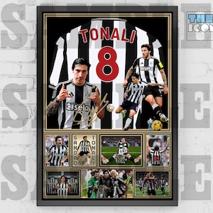 May include: Framed artwork featuring a soccer jersey with the name "TONALI" and the number "8" in red. The artwork includes multiple images of a soccer player in a black and white striped jersey, with the text "THE ICONS 99" in the upper right corner.