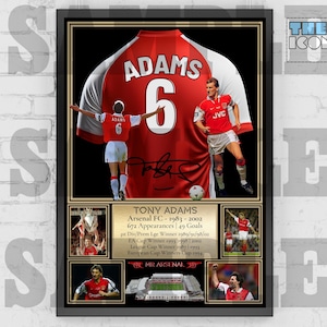 May include: A framed print of a red Arsenal soccer jersey with the name "ADAMS" and the number "6" on the back. The jersey is signed by Tony Adams, a former Arsenal player. The print includes a photo of Adams in the jersey, as well as a list of his accomplishments, including "MR ARSENAL".