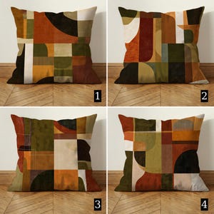 May include: Four square throw pillows with abstract geometric designs. Each pillow features a unique pattern in shades of brown, orange, green, black, and cream. The designs include squares, rectangles, and curved shapes, creating a modern, artistic look.