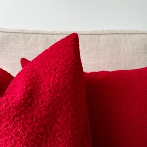 vivid red puffy boucle pillow close up