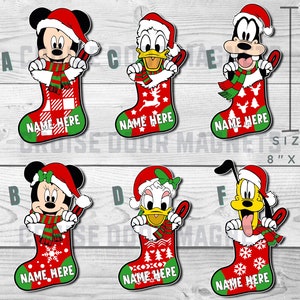 May include: Six Christmas stocking ornaments featuring Mickey Mouse, Minnie Mouse, Donald Duck, Goofy, and Pluto. Each stocking is red and green with a white snowflake pattern and the text "NAME HERE". The ornaments are 8 inches by 6 inches.