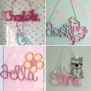 May include: Four wall-hanging name signs crafted from knitted yarn. The signs feature the names Charlotte with a mermaid, Josie with a flamingo, Jella with a flower, and Elina with a raccoon. Each piece includes a hanging cord with beads.