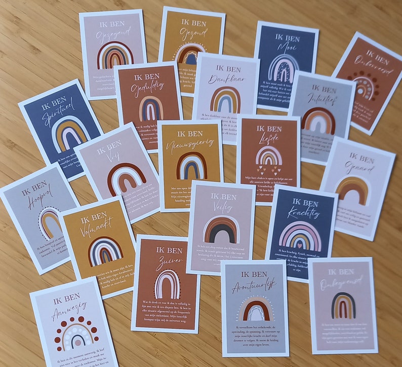 May include: A collection of 18 cards with rainbow designs and Dutch text. Each card features a different affirmation, such as "Ik ben spiritueel" (I am spiritual) and "Ik ben volmaakt" (I am perfect).