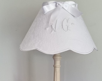 Old white embroidered napkin lampshade with bow.