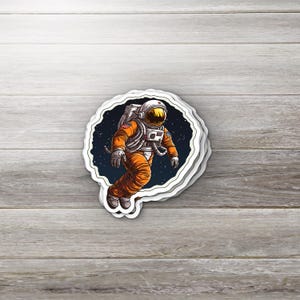 Orange Space Suit Astronaut Sticker • Cosmic Vinyl Sticker • Outer Space Aesthetic • Waterproof Laptop Sticker • Sci-Fi Gift for Stargazers