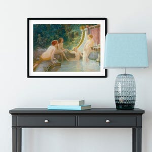May include: A framed art print depicting a classical scene of nude figures in a water setting. The artwork features a fountain and lush greenery, with soft lighting and a muted color palette.