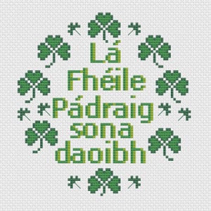 May include: A cross-stitch pattern featuring the Irish phrase "Lá Fhéile Pádraig sona daoibh" surrounded by green shamrocks.