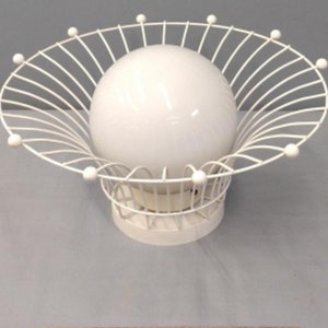 May include: White ceiling light fixture with a round, white globe surrounded by a white wire cage.