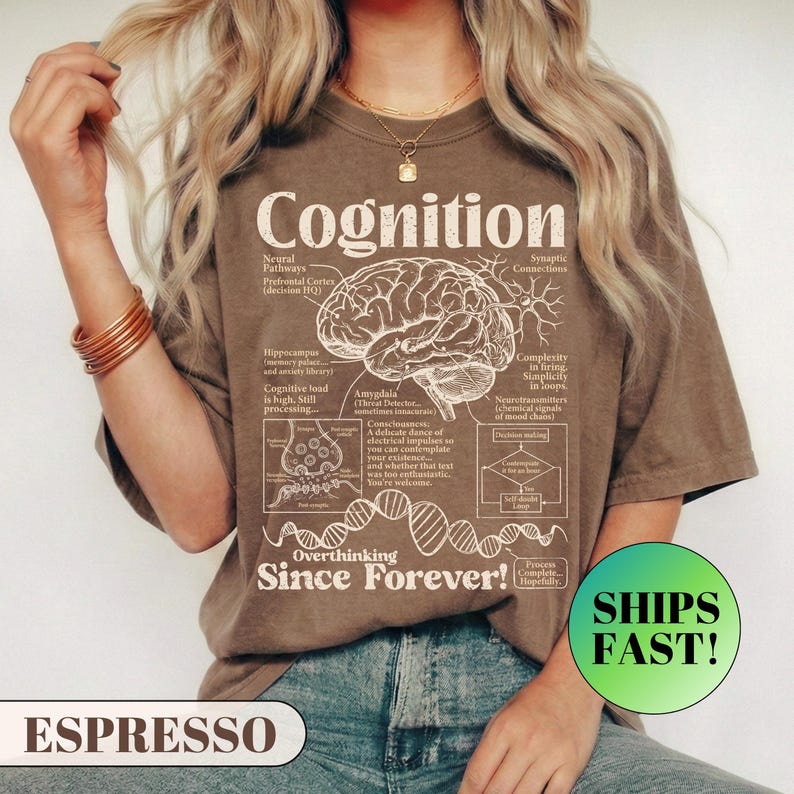 A model wearing a relaxed fit graphic t-shirt featuring a vintage anatomical diagram of a brain, synapses, and a DNA strand. The text reads Cognition and Overthinking Since Forever! with humorous scientific labels like Self-doubt Loop. A funny graphic tee for overthinkers and psychology lovers.