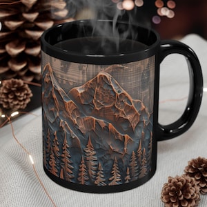 May include: Black coffee mug with a mountain and forest design. The mug features a detailed illustration of a mountain range and evergreen trees in shades of brown and blue. Steam rises from the mug, suggesting a hot beverage.