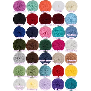 May include: A collection of yarn balls in various colors, including hot orchid, ocean, mango, and white. Each ball is labeled with its color name, such as "Black," "Red," and "Navy." The image showcases a wide range of hues for crafting projects.