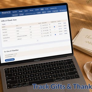 May include: A laptop displays a wedding planning software interface, showing gift tracking and to-do lists. Beside the laptop are "thank you" cards, a ribbon spool, and a vase of flowers. The text "Track Gifts & Thank-Yous" is at the bottom.