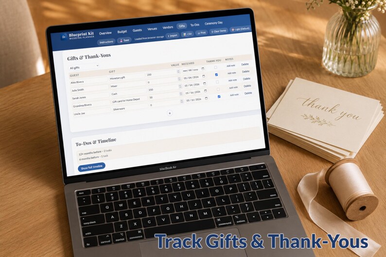 May include: A laptop displays a wedding planning software interface, showing gift tracking and to-do lists. Beside the laptop are "thank you" cards, a ribbon spool, and a vase of flowers. The text "Track Gifts & Thank-Yous" is at the bottom.