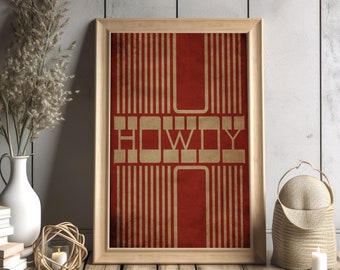 May include: A framed print with a red background and gold vertical lines. The word "HOWDY" is written in gold letters.