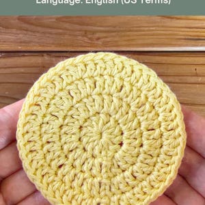 May include: A yellow crocheted flat circle with a textured stitch pattern. The text above reads: CLASSIC FLAT CIRCLE Step-by-Step Crochet Pattern. Skill Level: Beginner Friendly. Language: English (US Terms).