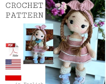 May include: Crochet pattern for a pink and brown doll with pigtails, wearing a pink dress and white shoes. The pattern is available in English and Polish.