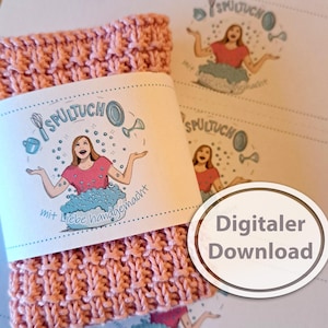 May include: A pink knitted dishcloth with a white label that says "Spültuch mit Liebe handgemacht". The label features a cartoon illustration of a woman with a dishcloth and bubbles. The text "Digitaler Download" is written in a white oval on a gray background.