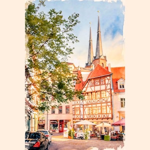 May include: Watercolour painting of a European town square with buildings featuring red tile roofs and timber-framed walls. A church with two spires rises in the background. Cars, a scooter, and people are visible.
