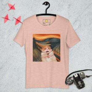 May include: A pink t-shirt with a graphic print of a hamster in the style of Edvard Munch's "The Scream".