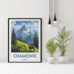 May include: A framed poster featuring a scenic mountain landscape with a brown mountain goat in the foreground. The poster has the text "Chamonix France" at the bottom.